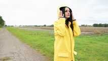 Miss Amira on the road in a Frisian mink, yellow rain dungarees and rubber boots