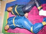 Stella and Leonie tied and gagged and hooded with tape both wearing sexy shiny nylon rainwear (Pics)