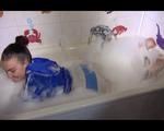 Jill posing and playing with water and foam in the bath tub wearing a sexy lightblue shiny nylon shorts and an oldschool blue rain jacket (Video)