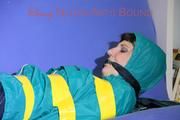 Mara tied and gagged with tape on a sofa wearing a supersexy shiny blue rain pants and a grren rain jacket (Pics) 