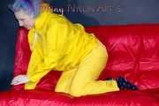MARA wearing a sexy yellow shiny nylon rain suit lolling and posing on a bed (Pics)