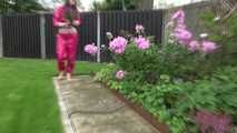 Watching Aiyana wearing supersexy pink shiny nylon rainwear while planting flowers in the garden (Video)