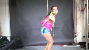 Marie M bound and gagged in shiny nylon Jacket and Shorts