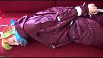 Mara tied and gagged on a red sofa wearing a sexy shiny bordeaux red oldschool skibib (Video)