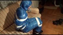 Mara tied, gagged and hooded on a sofa wearing a sexy blue shiny nylon down skibib (Video)