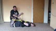 Hogtied in yellow ropes