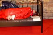 Mara tied and gagged on a princess bed in an old cellar wearing a sexy red sauna suit (Pics)