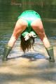 Stella wearing a supersexy green shiny nylon shorts and a green rain jacket as well as green rubber boots while jumping in puddles (Pics)