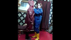 Lady Nadja and Miss Scarlett in  AGU rainwear trying bondage and a new harness gag (Video)