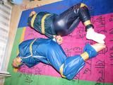 Stella and Leonie tied and gagged and hooded with tape both wearing sexy shiny nylon rainwear (Pics)