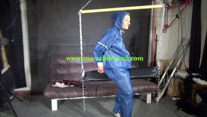 Watch Sandra bound gagged and wearing her shiny nylon Rainwear