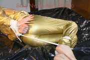 Pia tied, gagged and hooded on bed wearing a sexy golden rain combination and wings (Pics)