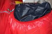 Watching sexy Jill wearing a red shiny nylon rain pants and an oldschool rain jacket under a red downjacket being tied and gagged with ropes and a ballgag on a bed (Pics)