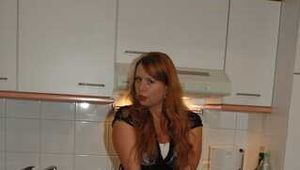 Chubby redhead  Benita stripping out of her black dress in the kitchen