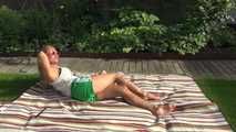 Watching sexy Sandra wearing a sexy green shiny nylon shorts and a white top taking a sun bath (Video9