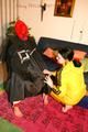 Jill tied, gagged and double hooded on a chair by an archive girl both wearing shiny rainwear (Pics)