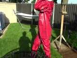 Watch Sandra watering the garden and wetting her shiny nylon oldschool Rainsuit in the Pool