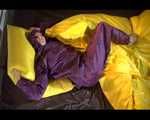 Lucy wearing a purple rain suit preparing her bed cloths for enjoying herself and the rain suit in bed lolling around (Video)