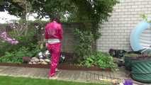 Watching Aiyana wearing supersexy pink shiny nylon rainwear while planting flowers in the garden (Video)