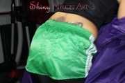 Watching sexy Sandra wearing a sexy black cycling shorts, a top and a sexy green shiny nylon shorts while preparing her bed (Pics)